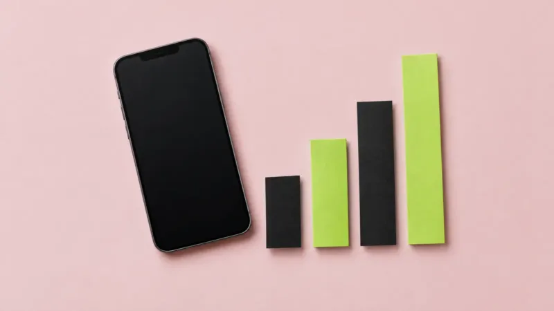 Smartphone beside rising black and lime paper bar charts on a pink backdrop, showing social media campaign metrics